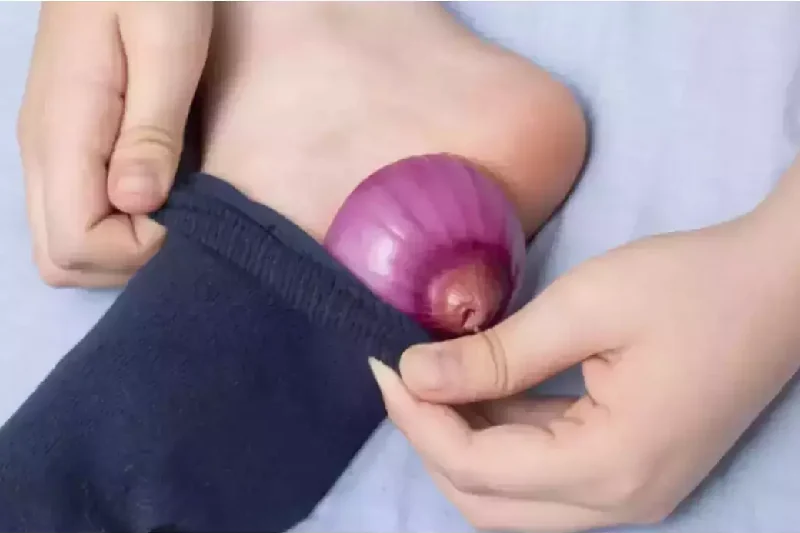 By placing onions on your feet